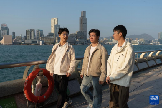   2月17日，在香港灣仔海濱長廊拍攝的何金淼（中）、溫建彬（右）和王皓霖。新華社發(fā)（龍鏡伊攝）