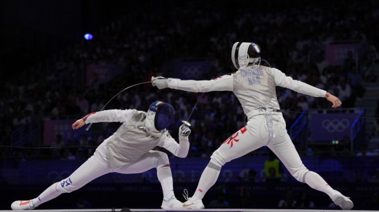 2024年7月29日，中國(guó)香港選手張家朗（右）在巴黎奧運(yùn)會(huì)擊劍項(xiàng)目男子個(gè)人花劍決賽中戰(zhàn)勝意大利選手菲利波·馬基，奪得冠軍。新華社記者 費(fèi)茂華 攝